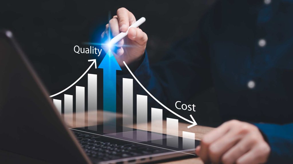 The image depicts a hand holding a pen and pointing to a graph on a laptop screen. The graph shows an upward trend for "Quality" and a downward trend for "Cost". This visual metaphor represents the concept of "Cost-Saving Business Solutions" where a company can improve quality while reducing costs through strategic business decisions.