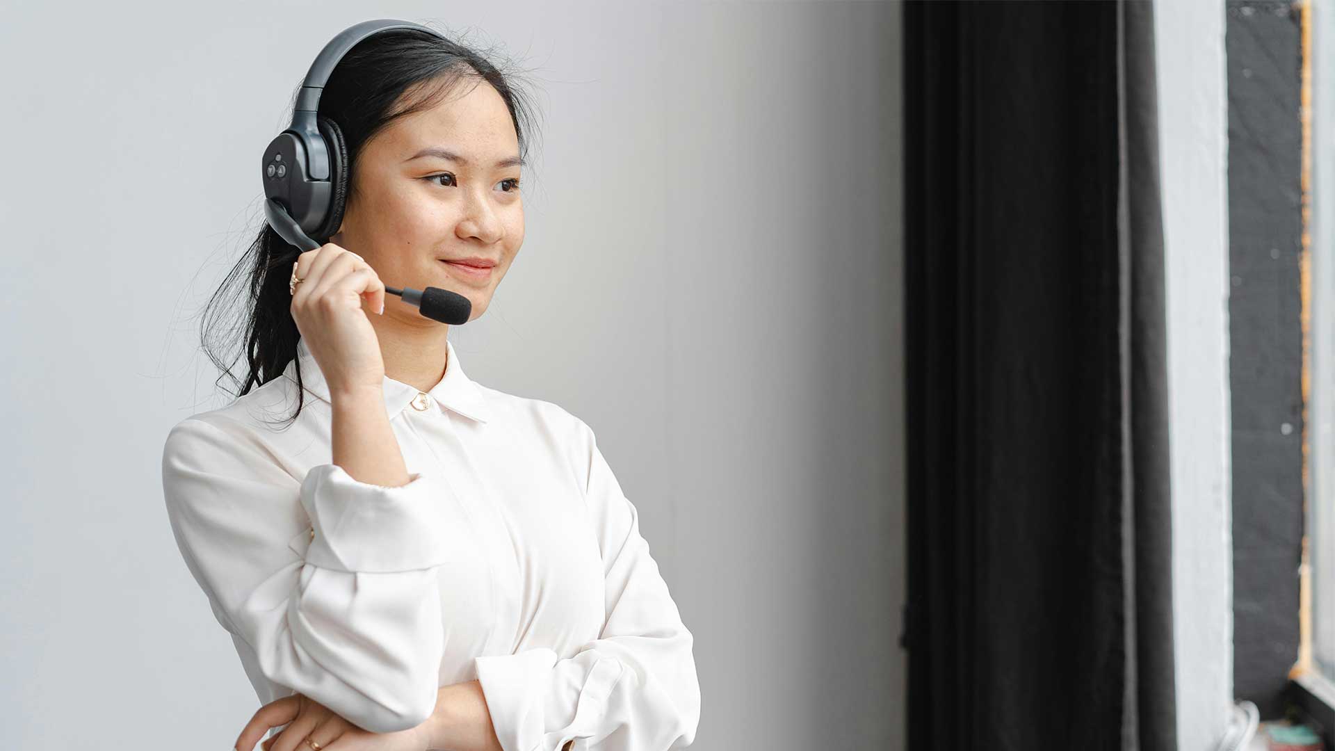 Customer service representative smiling with headphones on